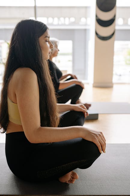 Woman relaxing on a yoga mat with her eyes closed, showing a state of peace.